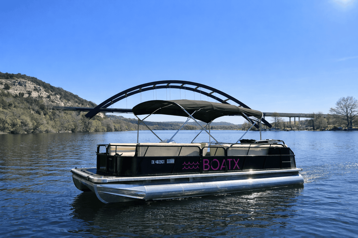 BOATX pontoon boat at Pennybacker Bridge Lake Austin scenic view